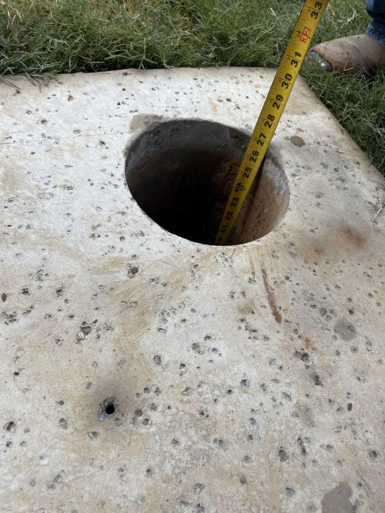 Fencing Contractor in Sherman TX Post hole in concrete with tape measure