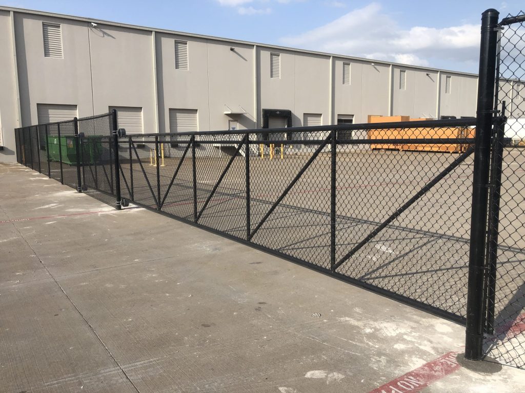 Black chain link fence at commercial warehouse lot