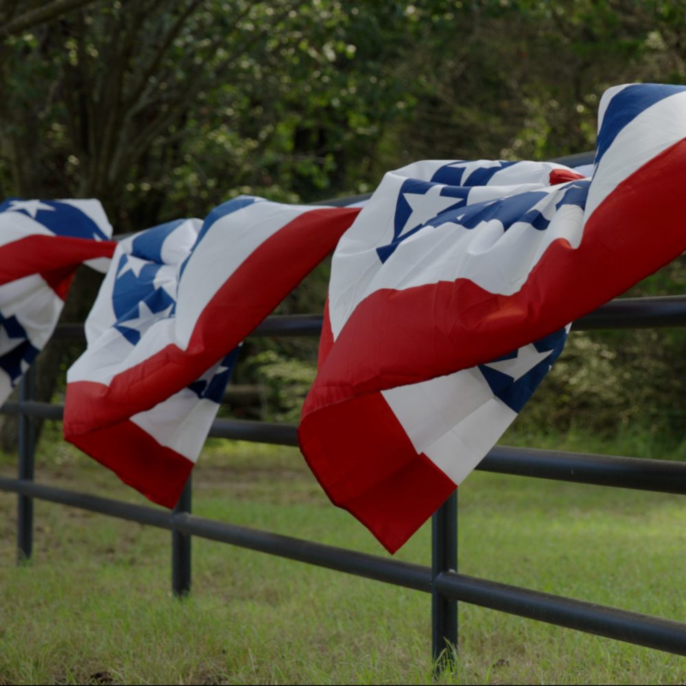 Flags on a pipe fence